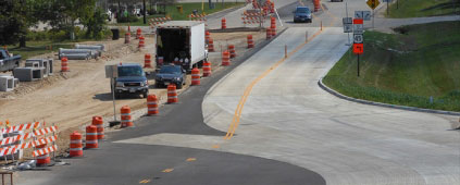 New concrete road parallels road under construction