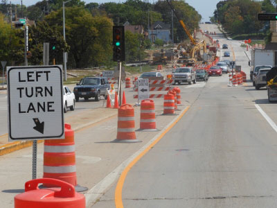 Orange barrels on new concrete road diverts traffic